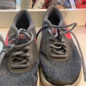 These are Nike sneakers, size 5 colors, dark, gray, and pink